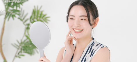 白い歯を見せて笑う女性の画像